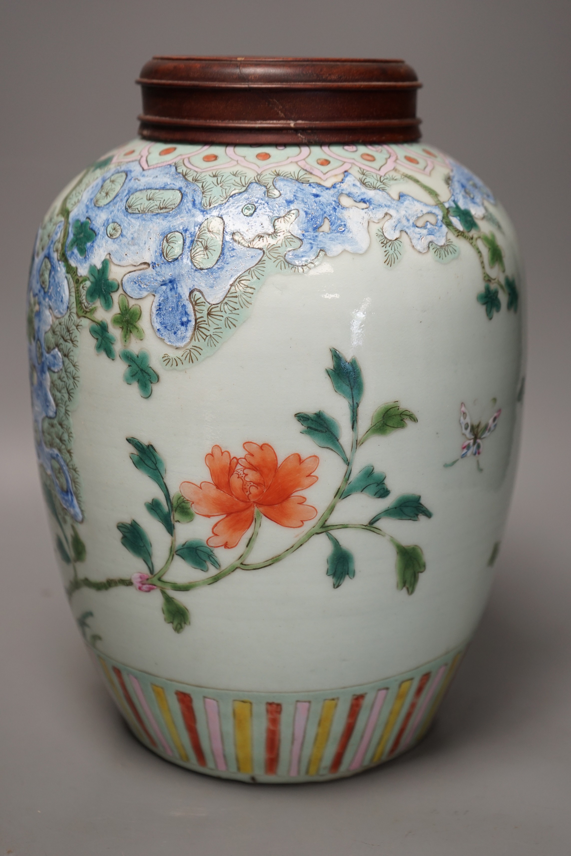 A 19th century Chinese famille rose 'phoenix' jar with wood cover, 30cm tall